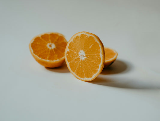 sliced orange fruit on white surface