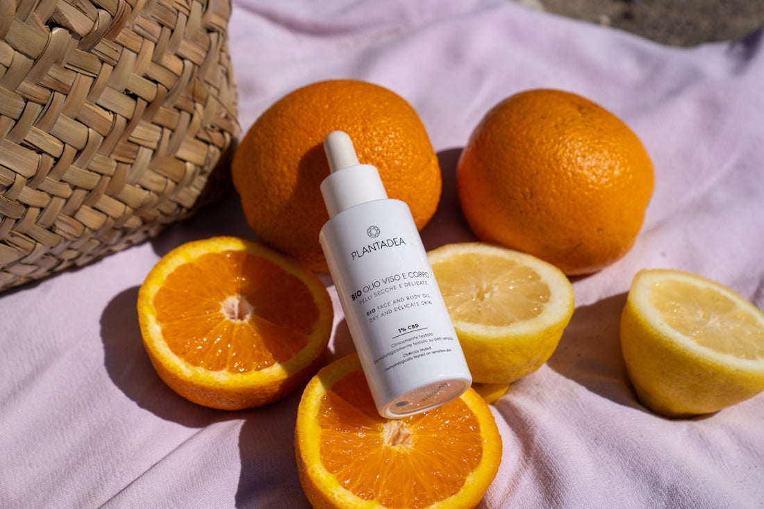 A bottle of eye cream sitting on top of a pile of oranges