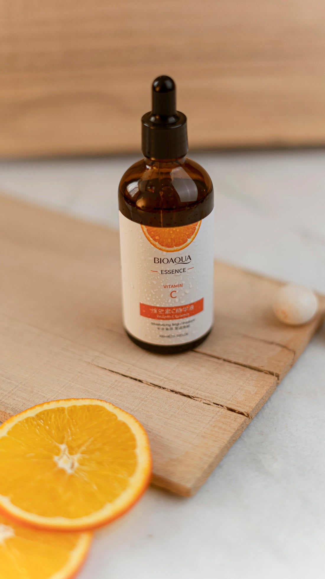 A bottle of vitamin oil sitting on top of a cutting board