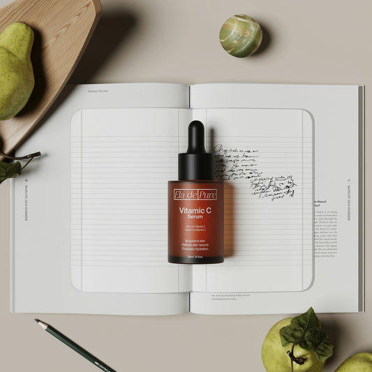 Vitamin c serum sits atop a notebook.